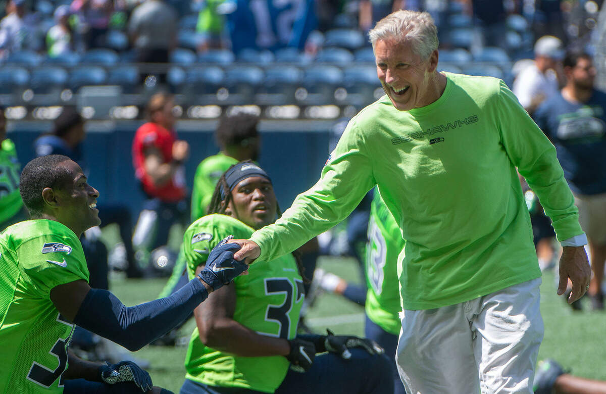 Always bubbly, Seahawks coach Peter Carroll greets players prior to the annual training camp mock game at Lumen Field in Seattle on August, 5, 202.