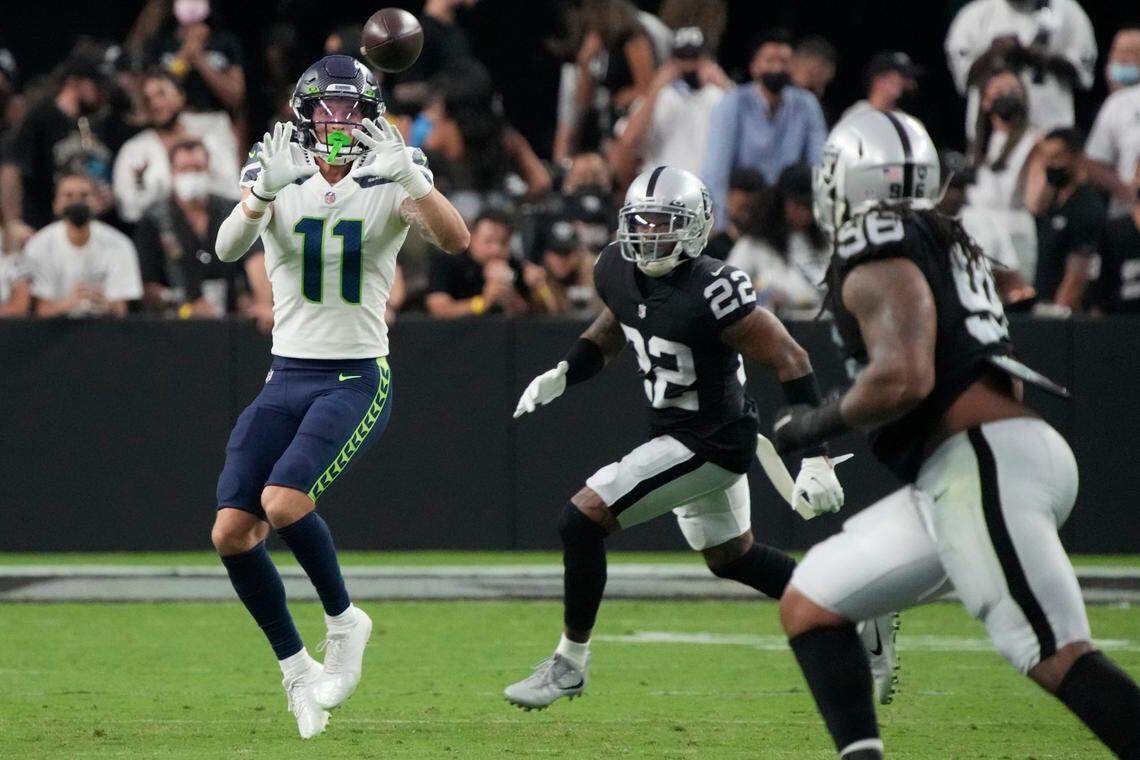 Seattle Seahawks wide receiver Cody Thompson (11) makes a catch against Las Vegas Raiders defensive back Keisean Nixon (22) during the first half of an NFL preseason football game, Saturday, Aug. 14, 2021, in Las Vegas. (AP Photo/Rick Scuteri)