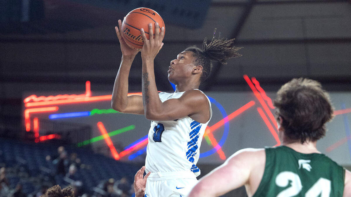 Federal Way’s Vaughn Weems glides down the lane between Skyline defenders Trey Crandall and Ryan Sheilds (24) during their state quarterfinal game at the WIAA state basketball tournament in the Tacoma Dome in Tacoma, Washington, on Wednesday, March 1, 2023. Federal Way won the game, 69-53.