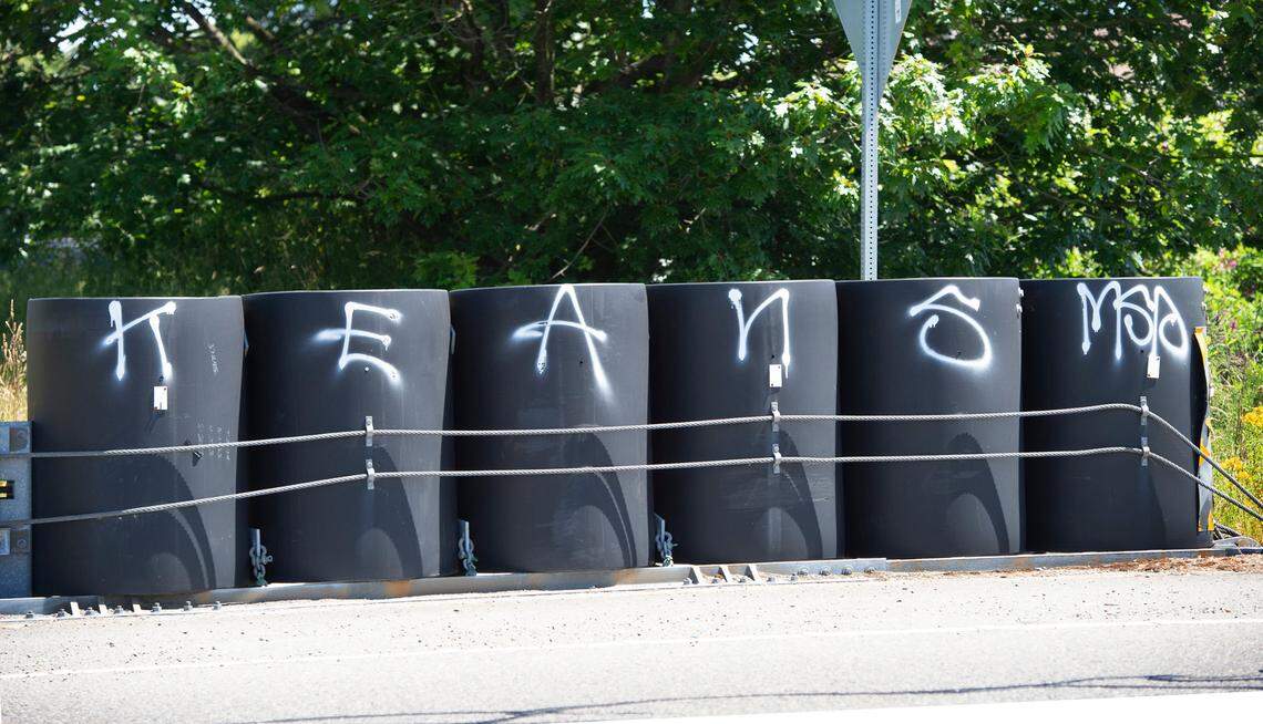 Graffiti defaces roadside barrels along Interstate 5 through Tacoma on Thursday, June 25, 2020.