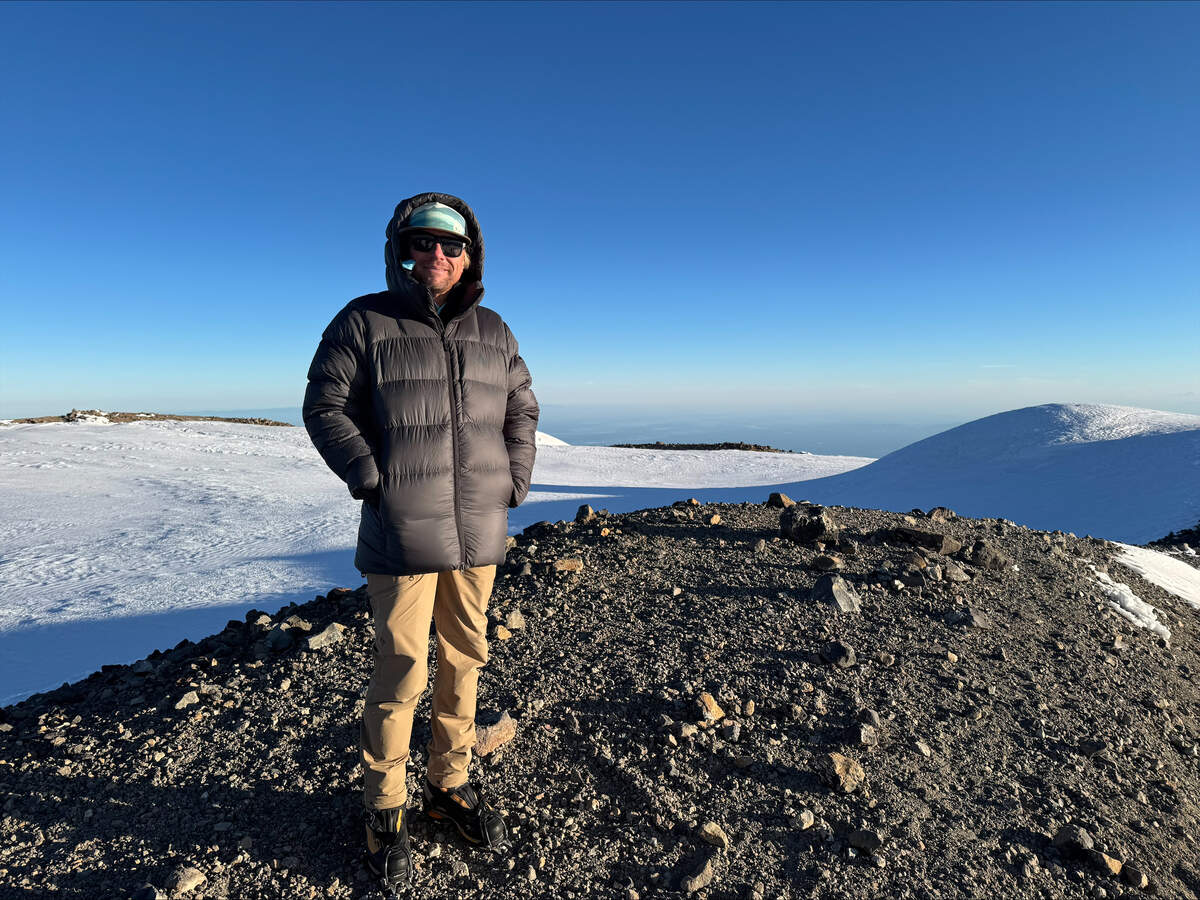 Mountain Guide Mike King stands atop Mount Rainier on his 100th summit.