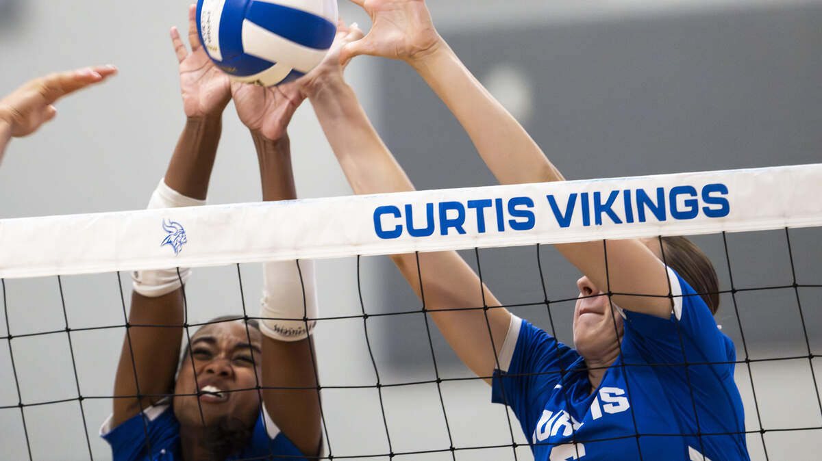 Curtis outside hitter Tala Johnson (20) and Curtis middle blocker Bella McNaughton (6) block a shot from Kennedy Catholic Lancers during the volleyball match at Curtis Senior High School, on Thursday, Sept. 18, 2025, in University Place, Wash.