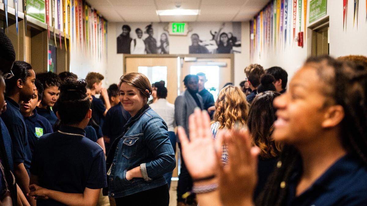 Students and faculty mingle and chat in a hallway before the start of a graduation ceremony at Destiny Charter Middle School in Tacoma.