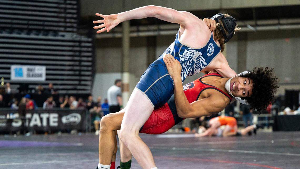 Silas Elijah Cater takes down Arlington Beau Gudde during the 126-pound 3A quarterfinal match at Mat Classic XXXIV on Friday, Feb. 17, 2023, at the Tacoma Dome in Tacoma, Wash. Cater defeated Gudde 10-5.