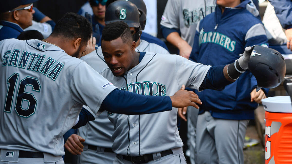 Seattle Mariners’ Tim Beckham, right, celebrates in the dugout with Domingo Santana (16) after hitting a three-run home run against the Chicago White Sox during the fifth inning of a baseball game in Chicago, Saturday, April 6, 2019. (AP Photo/Matt Marton)