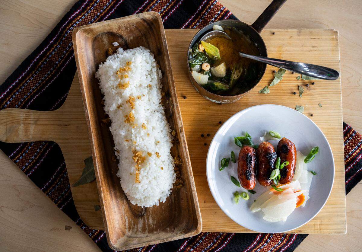 Chef Jan Parker harnesses local, seasonal ingredients for Jan Parker Cookery in Tacoma, Wash. This version of sinigang, a Filipino savory and sour soup, is traditionally made with tamarind but she used Oregon bay shrimp and okra, poured over rice and served with pickled daikon and carrots and Martin PureFoods longanisa.