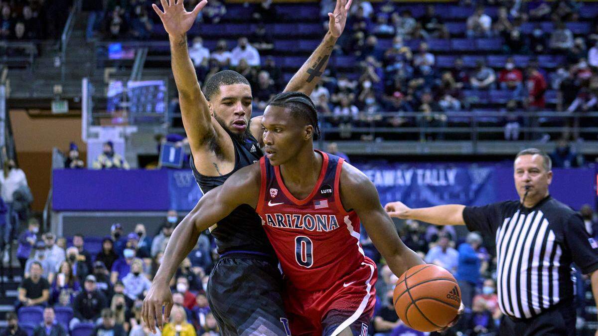 Arizona’s Bennedict Mathurin drives around Washington’s Terrell Brown Jr. during the first half of an NCAA college basketball game Saturday, Feb. 12, 2022, in Seattle. (AP Photo/John Froschauer)