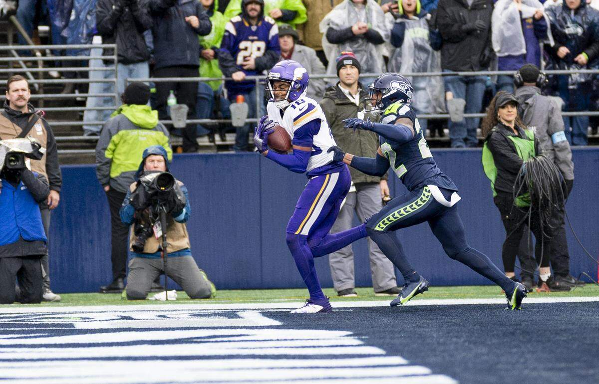 Minnesota Vikings wide receiver Justin Jefferson (18) catches a touchdown over Seattle Seahawks cornerback Tre Brown (22) during the second quarter of the game at Lumen Field, on Sunday, Dec. 22, 2024, in Seattle, Wash.