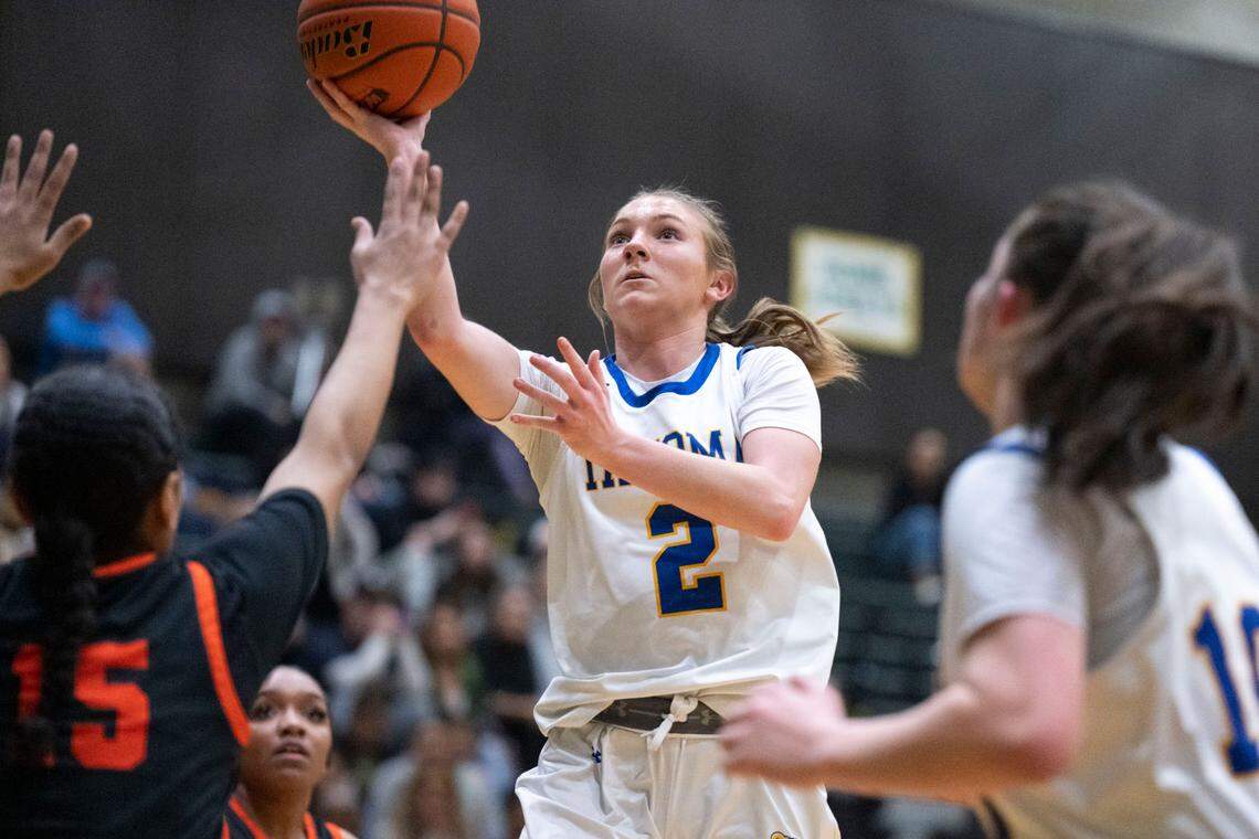 Tahoma guard Hope Hassmann (2) attempts a shot as Davis’ Tia Campbell (15) defends during the first quarter of a Class 4A state regionals game on Saturday, Feb. 25, 2023, at Auburn High School in Auburn, Wash.