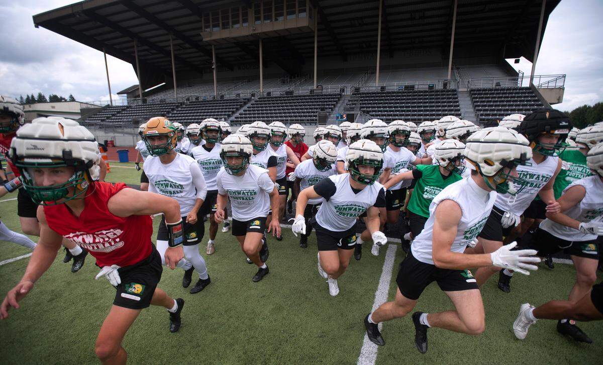 The Tumwater T-Birds take to the field for preseason football practice at Tumwater District Stadium in Tumwater, Washington, on Thursday, Aug. 22, 2024.
