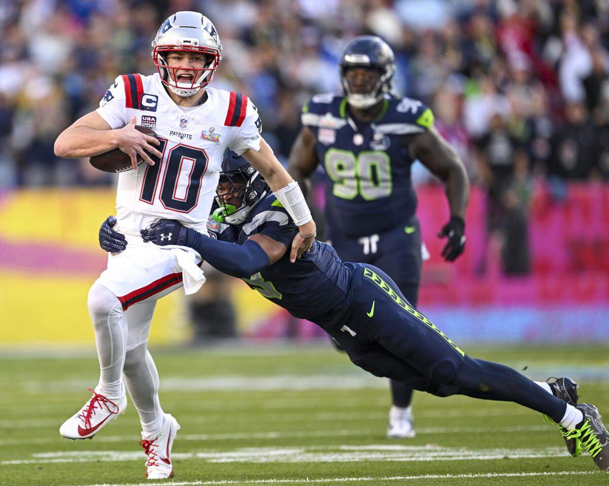 New England Patriots quarterback Drake Maye (10) is tackled by Seattle Seahawks safety Nick Emmanwori (3) during the first quarter of Super Bowl LX at Levi's Stadium on Feb. 8, 2026 in Santa Clara, Calif.