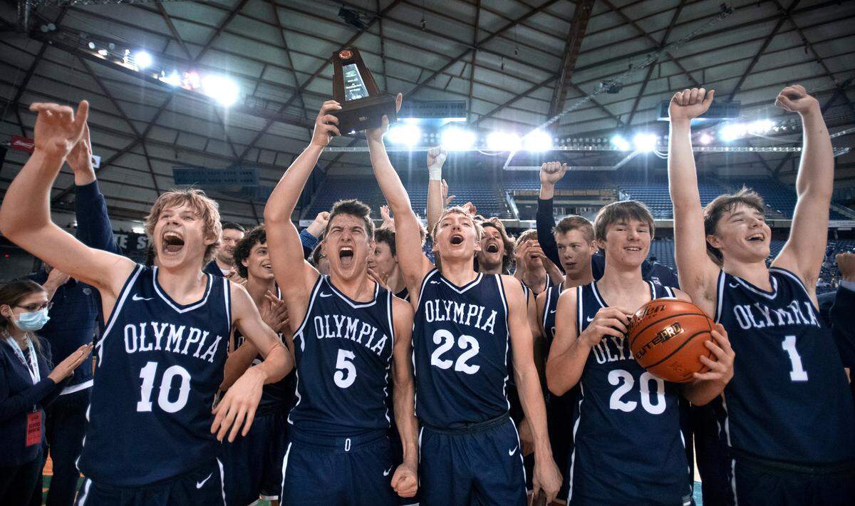 Olympia Bears hoist the third-place trophy following their 57-48 victory over the Union Titans the WIAA 4A Boys Basketball State Championships tournament in the Tacoma Dome in Tacoma, Washington, on Saturday, March 5, 2022.