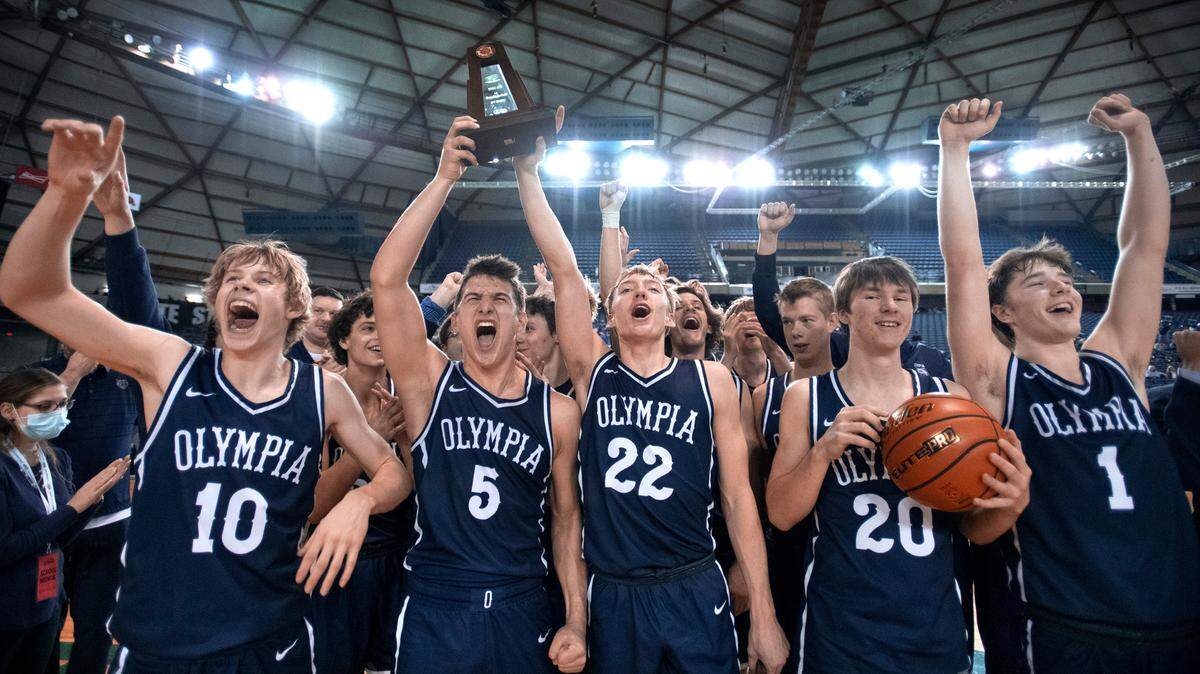 Olympia Bears hoist the third-place trophy following their 57-48 victory over the Union Titans the WIAA 4A Boys Basketball State Championships tournament in the Tacoma Dome in Tacoma, Washington, on Saturday, March 5, 2022.