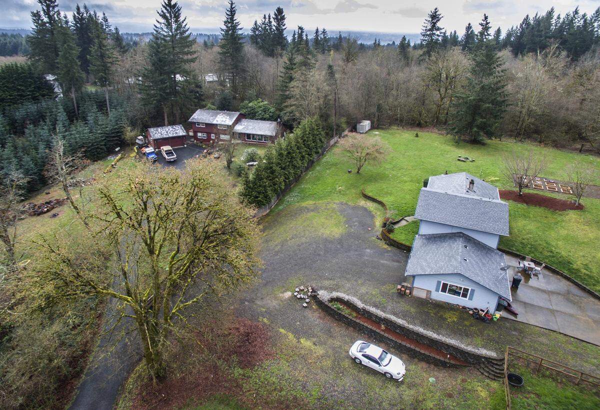 The Hart family’s house, right, was next door to the home of Bruce and Dana DeKalb, in a rural neighborhood east of Woodland, about halfway between Longview and Vancouver.