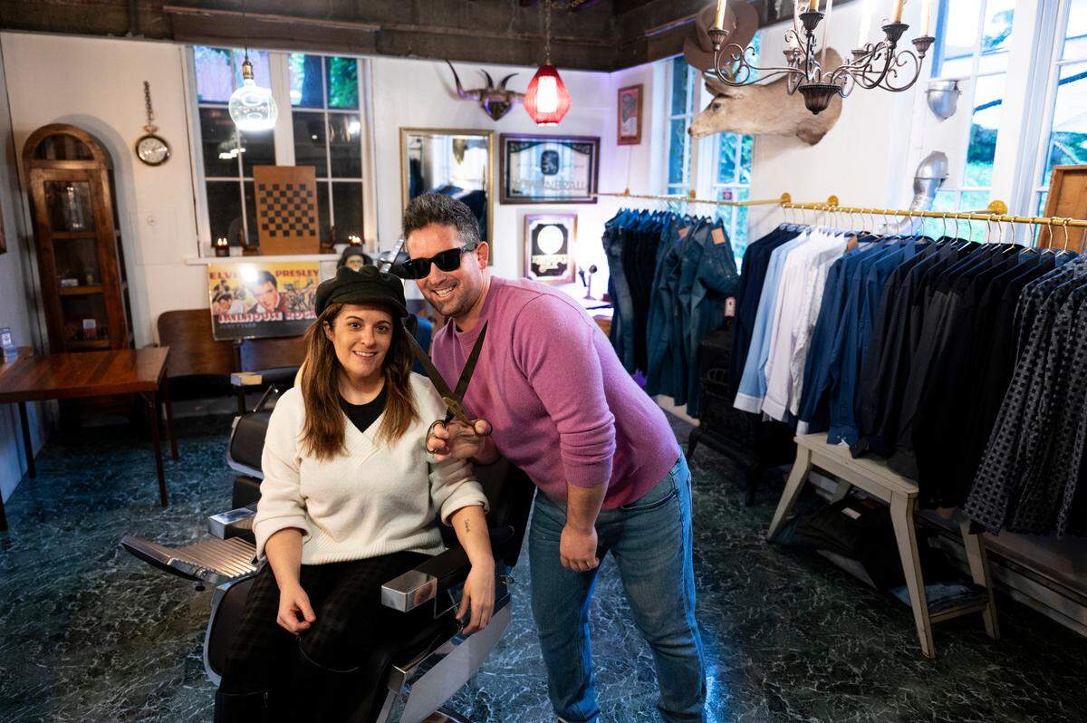 Co-owners Starr Hall and her boyfriend, Bruce Hillenbach pose for portrait at the One:11 speakeasy barbershop behind the gentlemen’s store, on Wednesday, Jan. 10, 2024, in Gig Harbor, Washington.