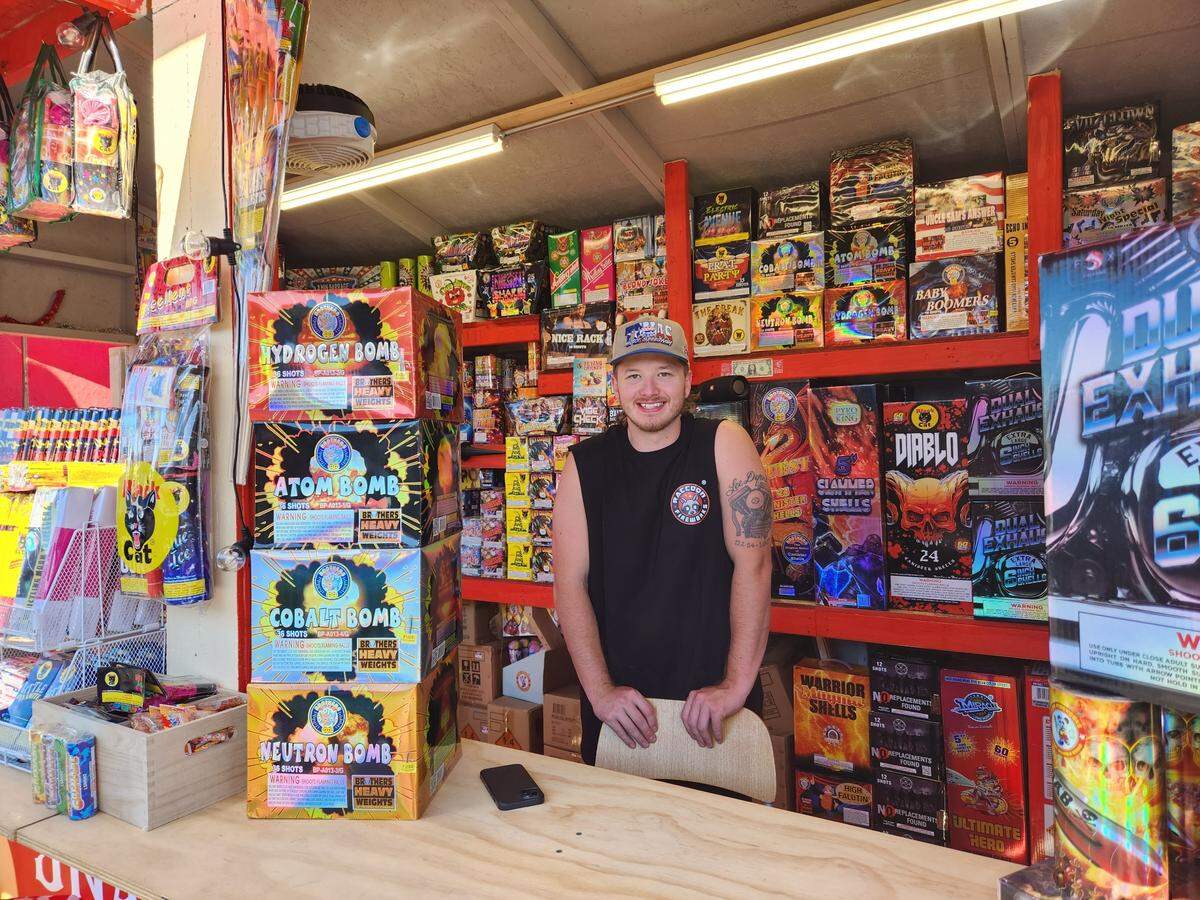 Firecracker vendor Kyegar Deford stands inside his booth at Firecracker Alley in Tacoma on June 29, 2023.