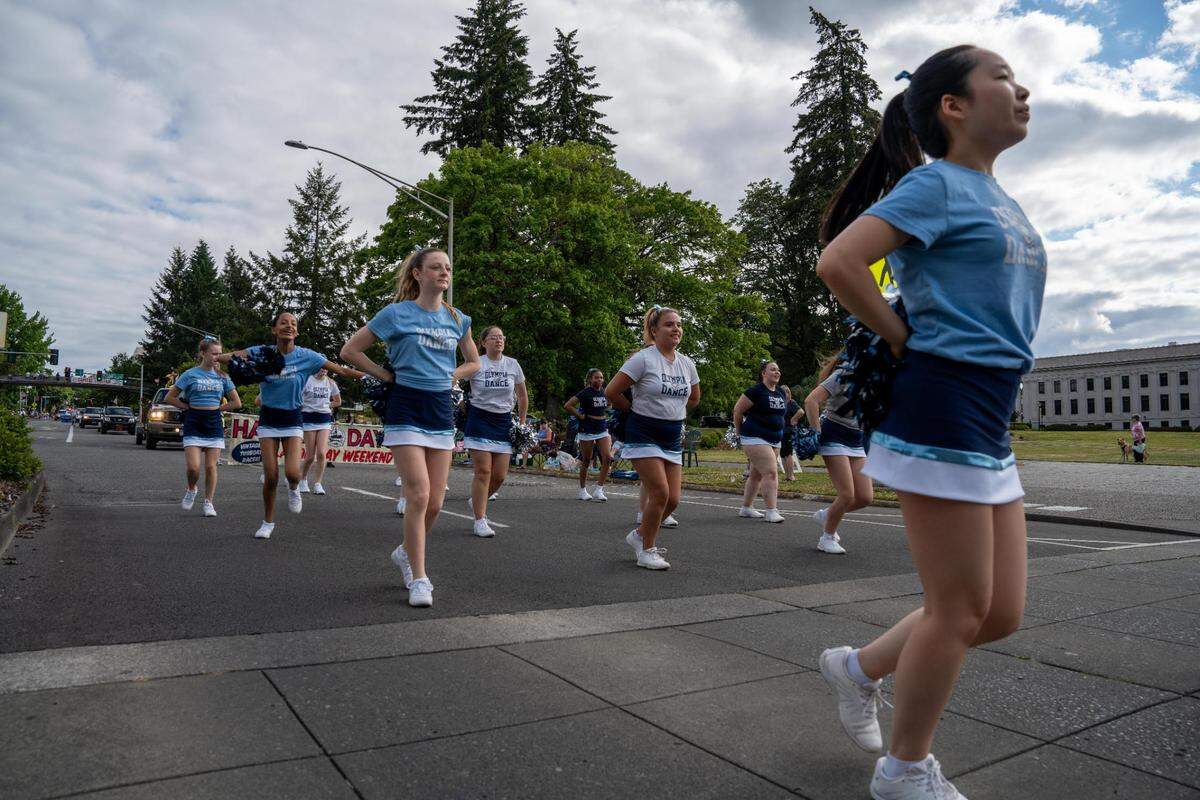 The Olympia Dance team makes their way down the parade route while dancing and interacting with the attendees of the Lakefair Grand Parade in Olympia, Wash. on July 16, 2022