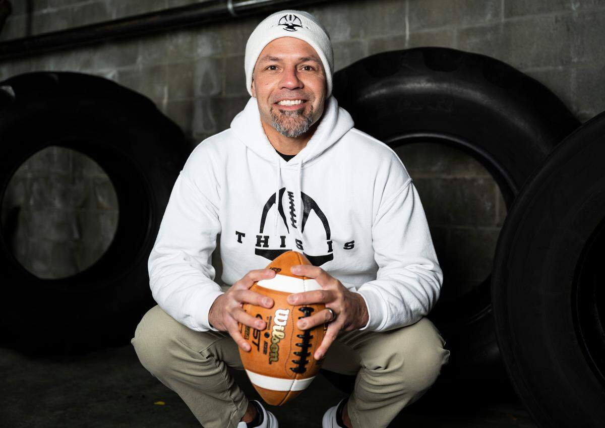 Yelm football head coach Jason Ronquillo poses for a portrait after being selected as coach of the year for The News Tribune’s 2022 All-Area football team, at Mount Tahoma High School in Tacoma, Wash. on Dec. 4, 2022.