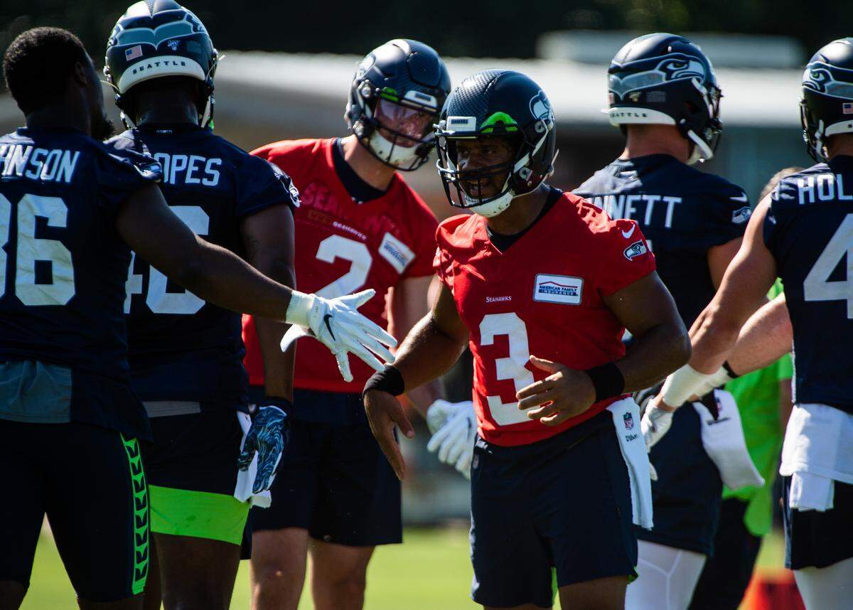 Russell Wilson greets players during the Seattle Seahawks training camp at the Virginia Mason Athletic Center in Renton, Wash., on Thursday, July 25, 2019.