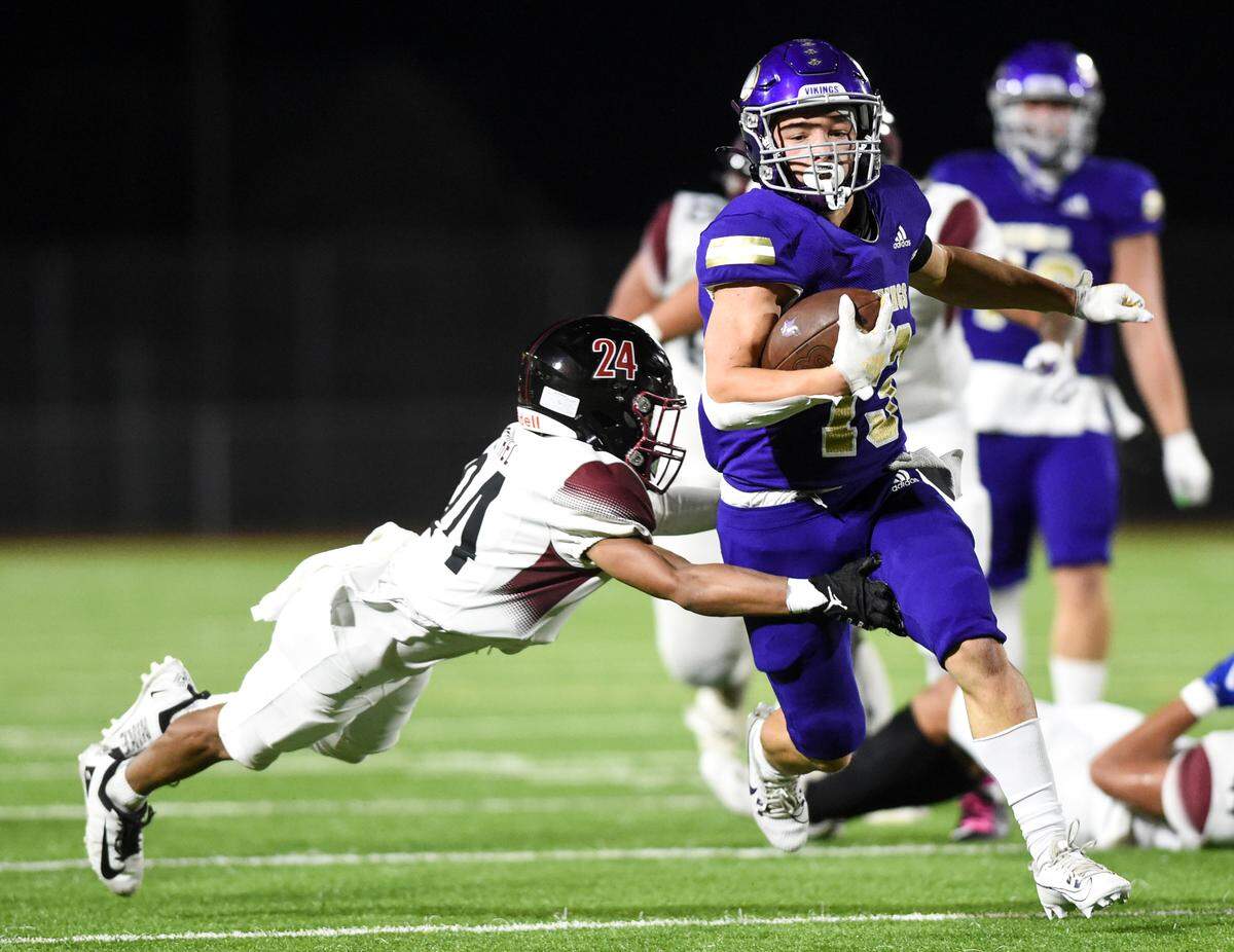 Puyallup’s Kyson Douglas (13) picks up yards after the catch against Bethel’s Jayvonn Meyers (24) during the first half of the game at Sparks Stadium, Thursday, Oct. 12, 2023, in Puyallup, Wash.