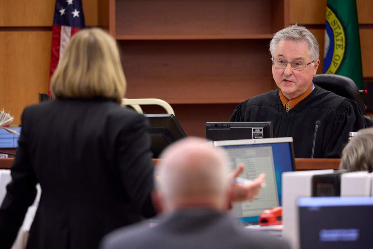 Washington state Assistant attorney general Lori Nicolavo, left, argues for the use of a video as evidence with Judge Bryan Chushcoff, right, during the trial of Tacoma Police officers accused in the death of Manny Ellis held at Pierce County Superior Court, Thursday, Oct. 19, 2023, in Tacoma, Wash. Officers Christopher Burbank, Matthew Collins and Timothy Rankine are charged. (John Froschauer/Pool Photo AP)