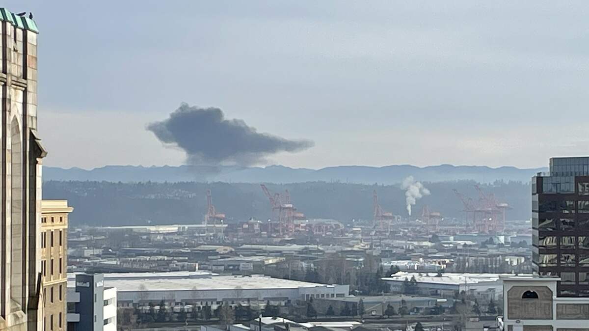 A dark plume of smoke lingered over the Tacoma Tideflats on Feb. 4, 2026 after a fire at an industrial facility.