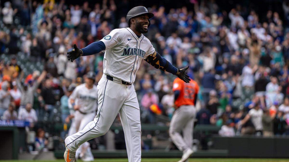 Apr 9, 2025; Seattle, Washington, USA;  Seattle Mariners left fielder Randy Arozarena (56) celebrates a walk-off walk against the Houston Astros at T-Mobile Park. Mandatory Credit: Stephen Brashear-Imagn Images