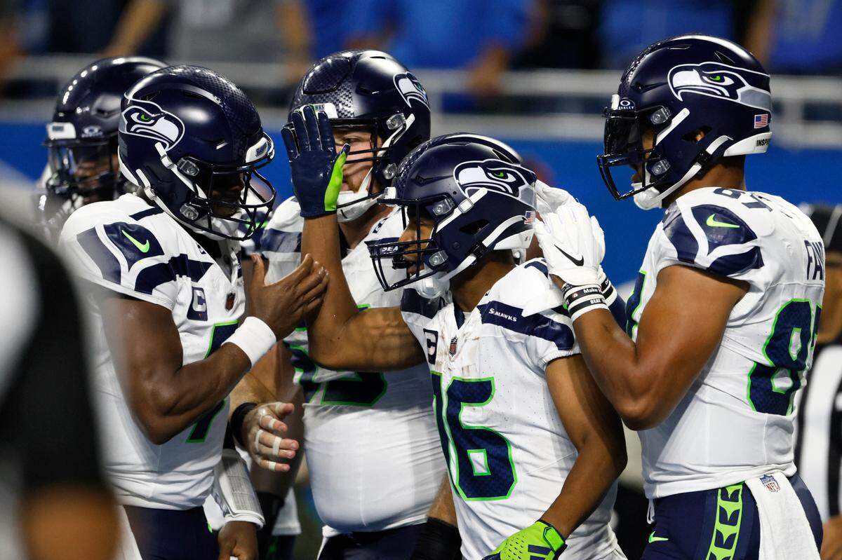 Seattle Seahawks wide receiver Tyler Lockett (16) celebrates with teammates after catching a 3-yard touchdown pass during the second half of an NFL football game against the Detroit Lions, Sunday, Sept. 17, 2023, in Detroit. (AP Photo/Duane Burleson)