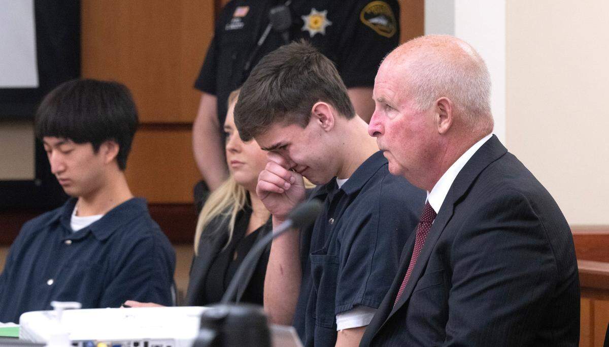 Justin Yoon (far left) and Gabriel Davies react as their sentence of 150 months in prison is announced in Pierce County Superior Court in Tacoma, Washington, on Friday, Nov. 3, 2033, for second-degree murder in the killing of Daniel McCaw at his home in Orting in September.