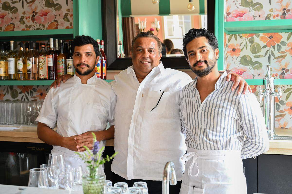 Brothers Jehan de Alwis (left) and Mikey de Alwis (right) pose for a portrait behind the bar with their father Mike de Alwis on Wednesday, July 17. Their second restaurant, Chez Lafayette, is now open in downtown Tacoma.