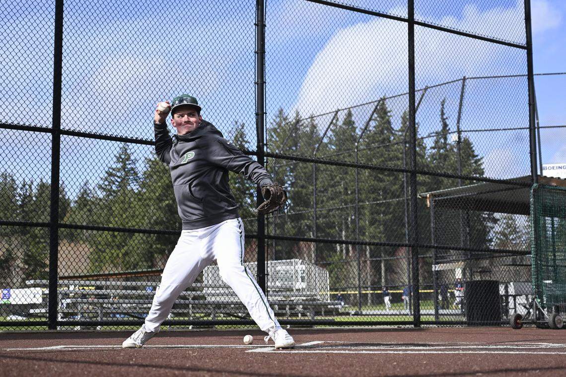 Peninsula catcher Pete Browand runs drills from behind the plate on Monday, March 9, 2026, at a practice in Gig Harbor, Wash.