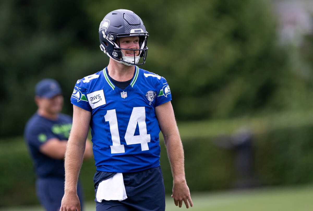 Seattle Seahawks quarterback Sam Darnold (14) reacts to a pass during training camp at Virginia Mason Athletic Center on Friday, July 25, 2025, in Renton, Wash.