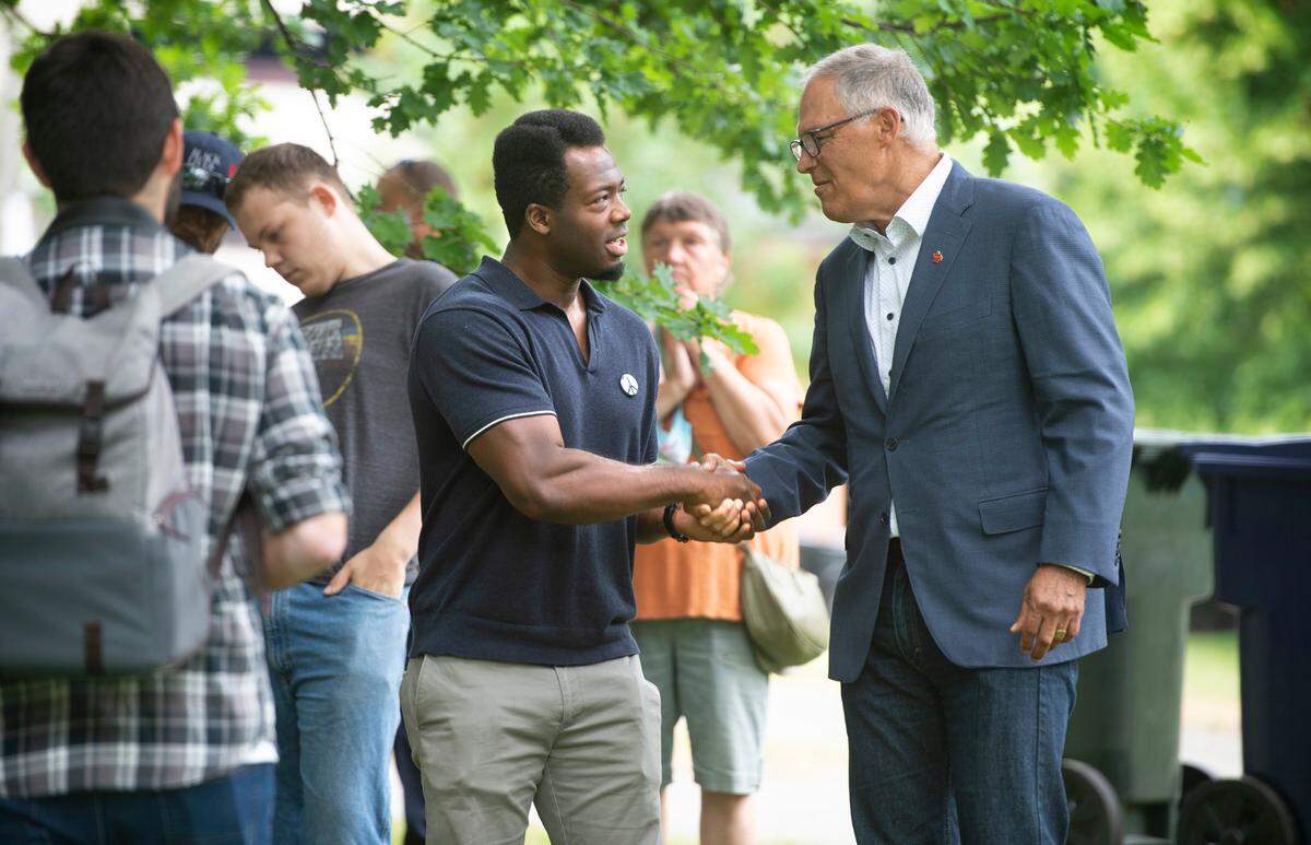 FILE: Kwabi Amoah-Forson of Tacoma thanks Washington Governor Jay Inslee during the “Open Washington” celebration at Wright Park in Tacoma, Washington, on Wednesday, June 30, 2021.