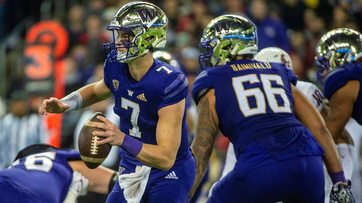 Washington quarterback Sam Huard (7) scramble out of the pocket as he looks for an open receiver during the third quarter of a Pac-12 game against against Washington State on Friday evening at Husky Stadium in Seattle.