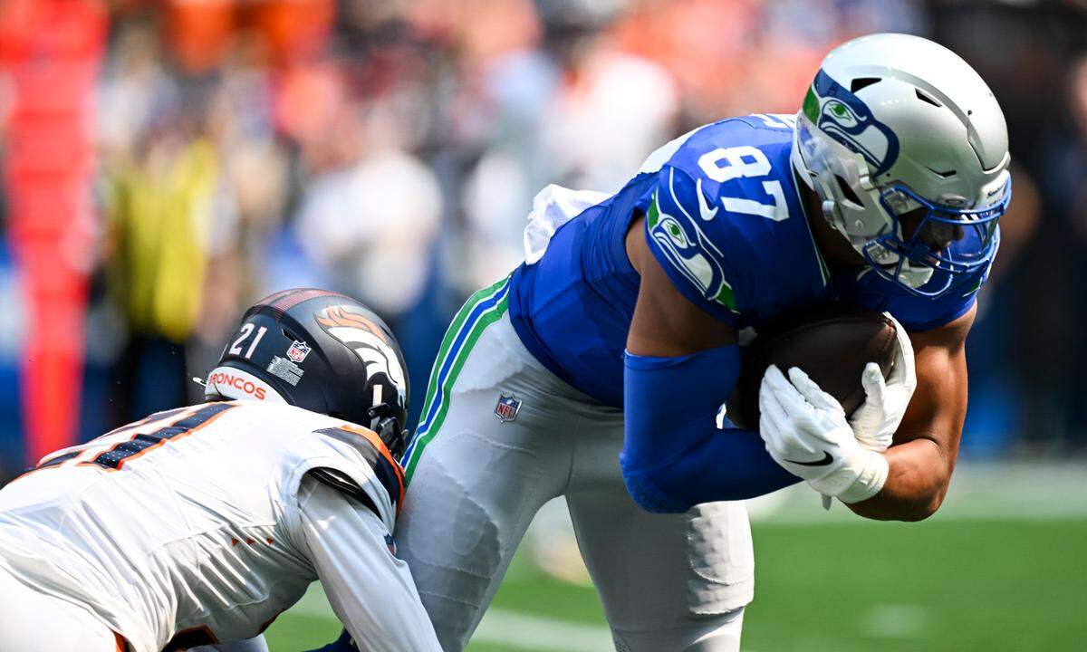 Seattle Seahawks tight end Noah Fant (87) is tackled by Denver Broncos cornerback Riley Moss (21) after the reception during the first quarter of the game at Lumen Field, on Sunday, Sept. 8, 2024, in Seattle, Wash.