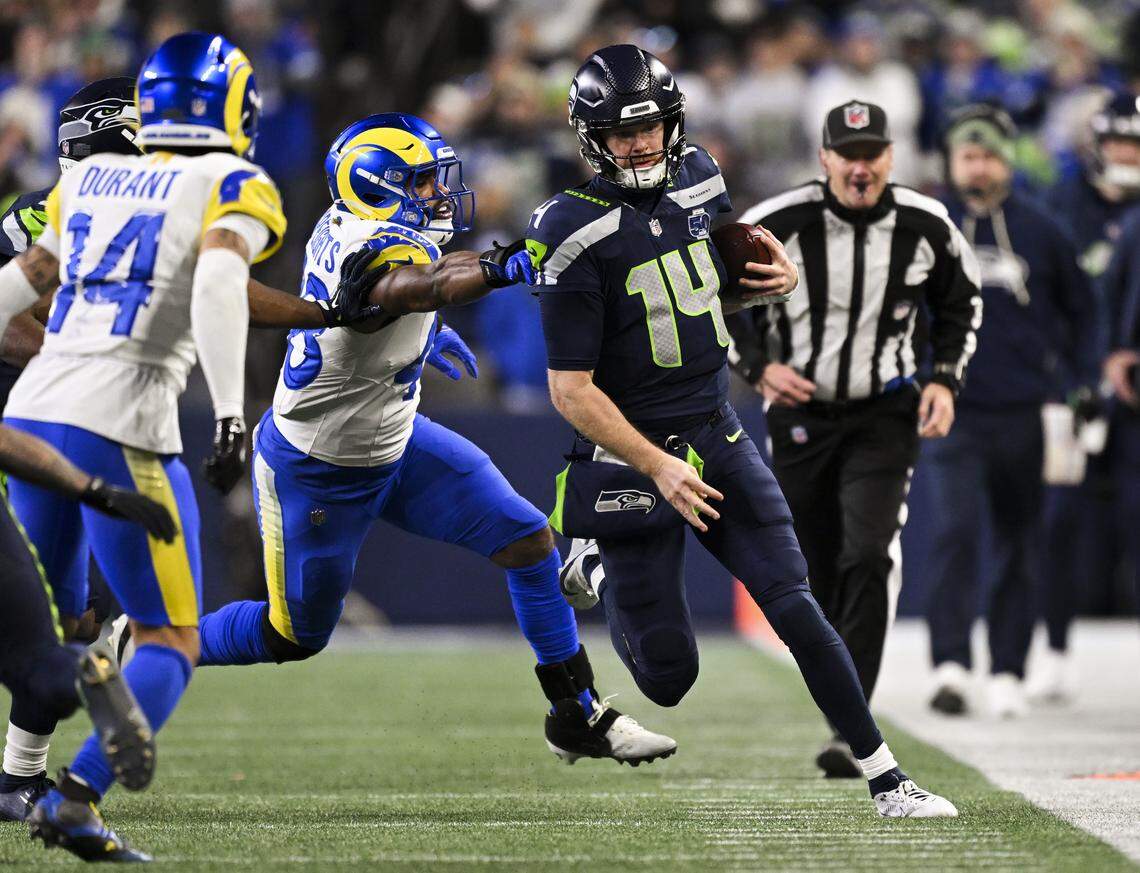 Seattle Seahawks quarterback Sam Darnold (14) rushes 14 yards against the Los Angeles Rams during the fourth quarter of the NFC Championship game at Lumen Field, on Sunday, Jan. 25, 2026, in Seattle.