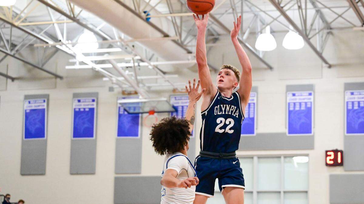 Olympia guard Parker Gerrits (22) attempts a shot as Curtis guard Gabe Martin (2) defends during the second quarter of a 4A South Puget Sound League game on Friday, Jan. 21, 2022, at Curtis High School in University Place, Wash.