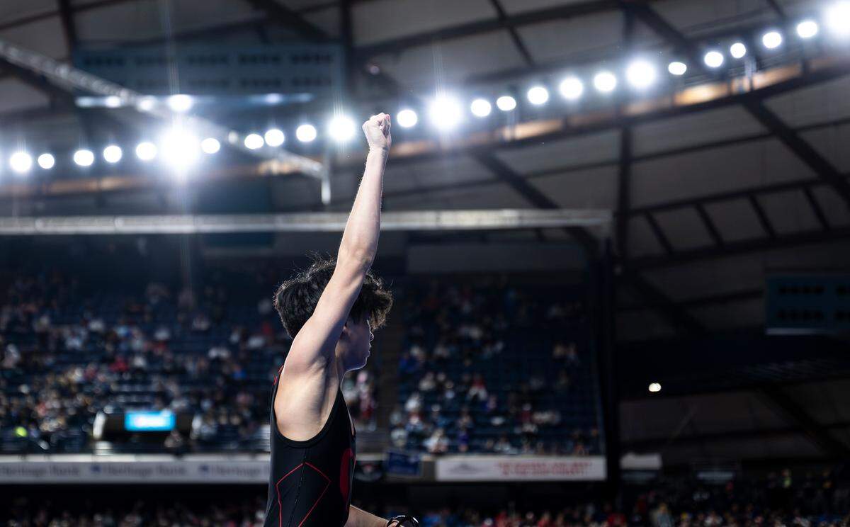 Orting’s Alan Salguero Jr. holds his hand up after beating Othello’s Mason Russell by fall in the 2A 126-pound quarterfinal match during day one of the Mat Classic XXXV at the Tacoma Dome on Friday, Feb. 16, 2024, in Tacoma, Washington.