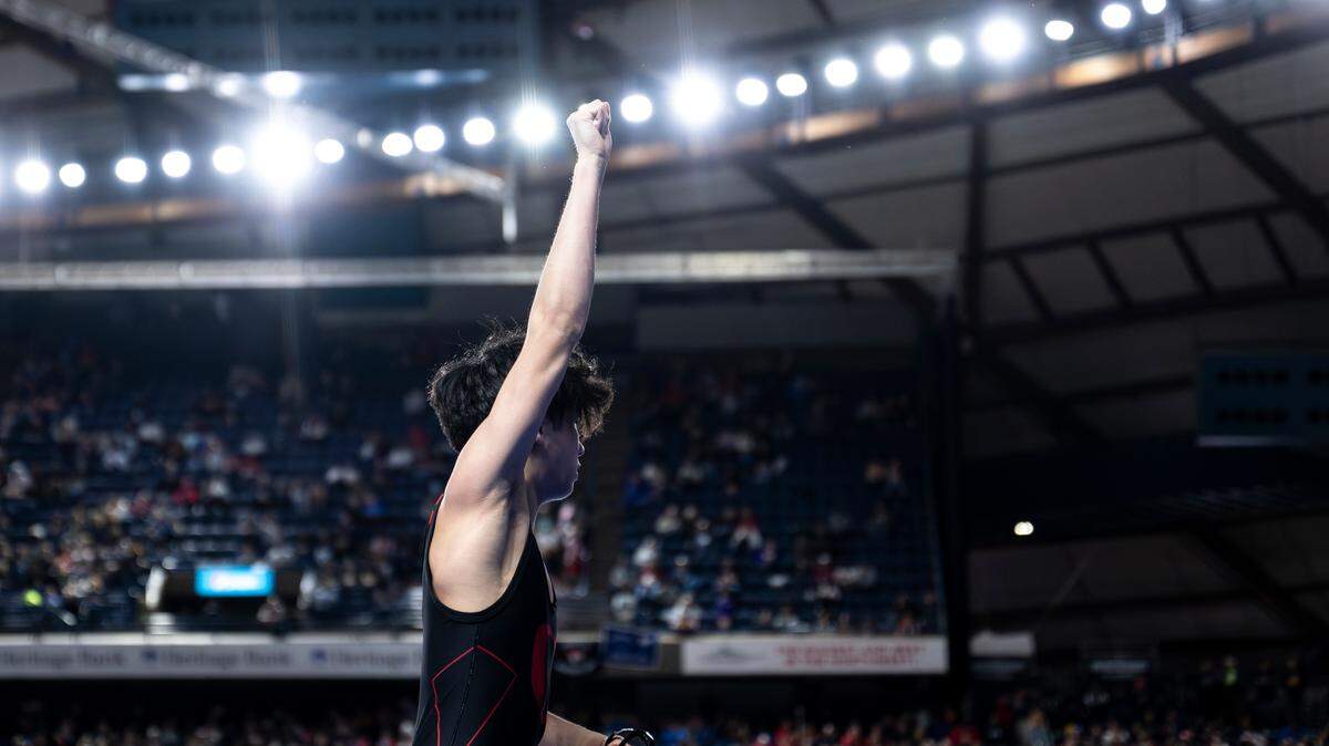 Orting’s Alan Salguero Jr. holds his hand up after beating Othello’s Mason Russell by fall in the 2A 126-pound quarterfinal match during day one of the Mat Classic XXXV at the Tacoma Dome on Friday, Feb. 16, 2024, in Tacoma, Washington.