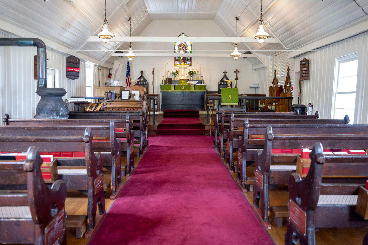 An old potbelly stove sits on one side of the nave of the Old St. Peter’s Church in Tacoma, on Thursday, Aug. 10, 2023. The church used the stove up until the 1980s to keep its congregants warm during service. The church was built in 1873 and is celebrating its 150th anniversary on Saturday, Aug. 12, 2023.