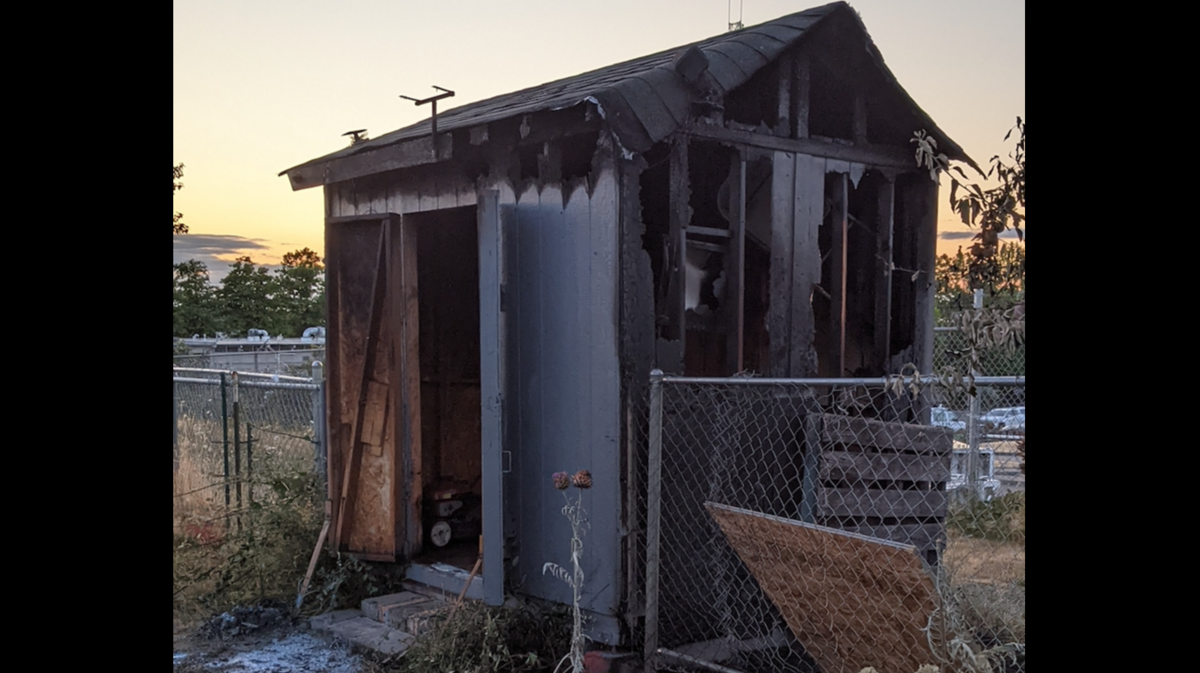 The blackened 40th Street Community Garden shed hours after it burned in southern Tacoma on Thursday, July 27.