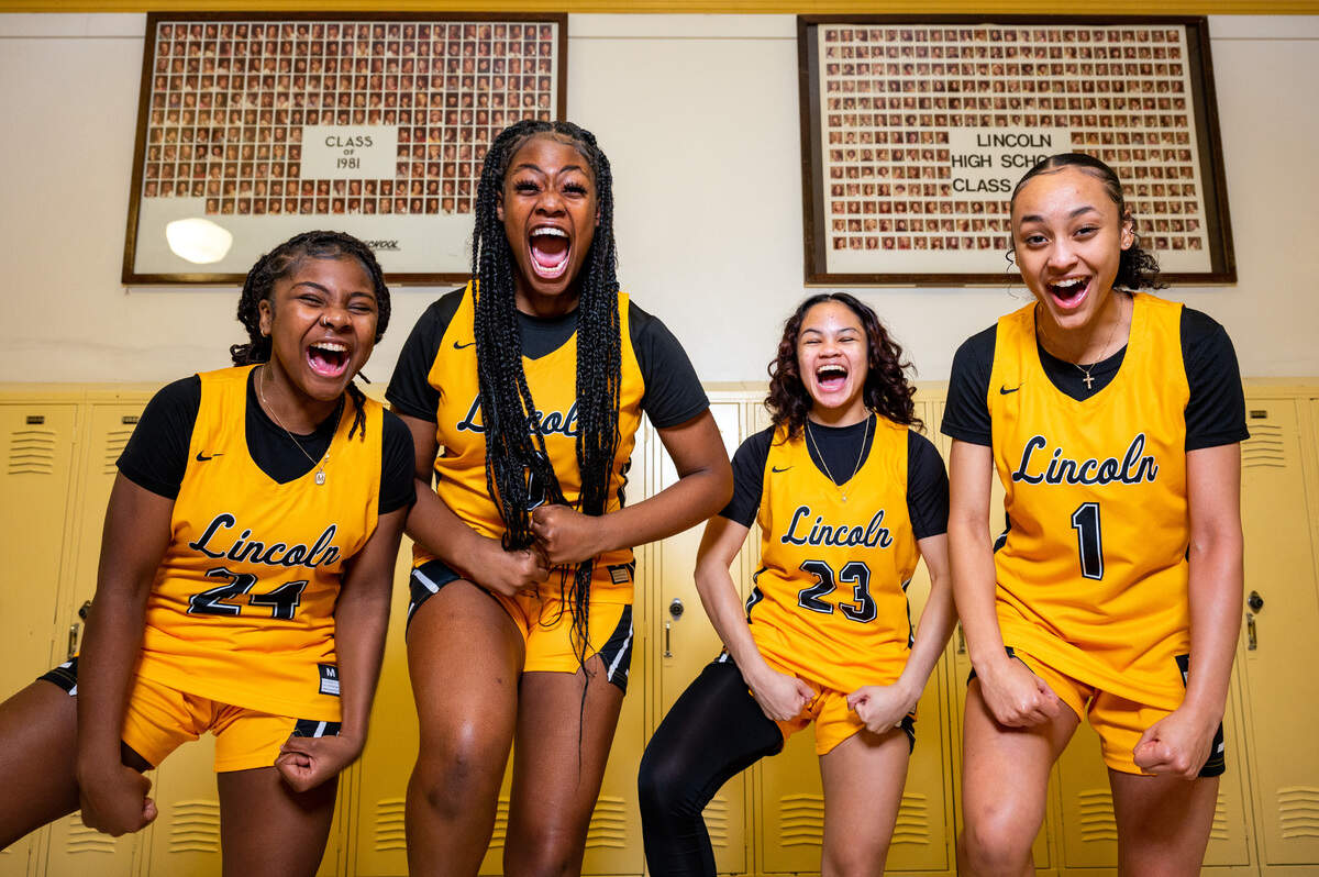 Lincoln junior Malani Warren (left) sophomore De’Andrea Woods-Singleton (center-left), sophomore Jaleigha Robinson (center-right) and Ciona Wells scream “Let’s Go!” for a portrait in the hallway at Lincoln High School on Thursday, Jan. 20, 2022, in Tacoma, Wash.