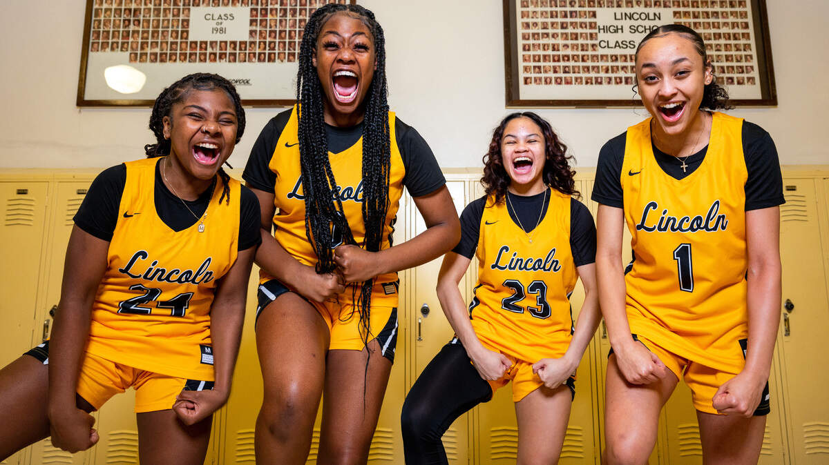 Lincoln junior Malani Warren (left) sophomore De’Andrea Woods-Singleton (center-left), sophomore Jaleigha Robinson (center-right) and Ciona Wells scream “Let’s Go!” for a portrait in the hallway at Lincoln High School on Thursday, Jan. 20, 2022, in Tacoma, Wash.