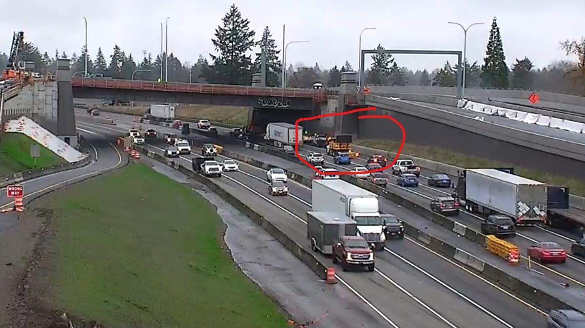 Construction crews are blocking the right lane of northbound I-5 to fix a broken catch basin lid.