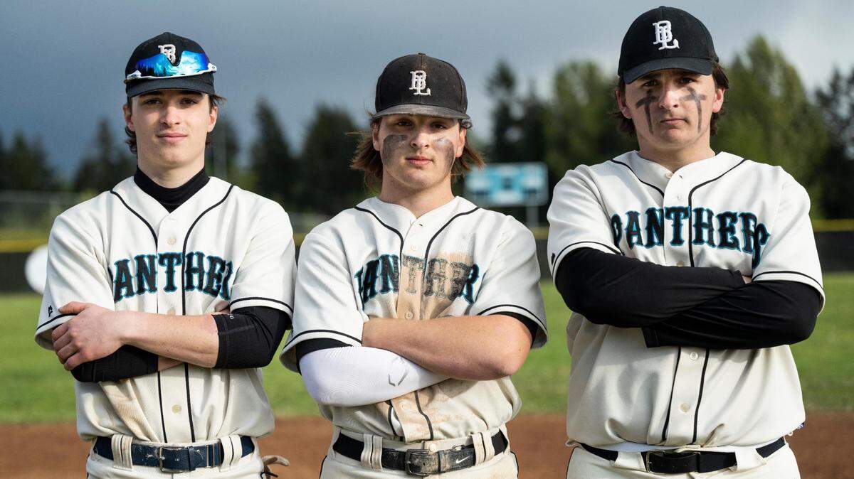 Bonney Lake High School varsity baseball seniors center fielder Brennan Carbonell (7), left, shortstop Cameron Duggan (3), center, and pitcher Nic Lewandowski (24), right, pose for a portrait after the district tournament game against Bainbridge at Bonney Lake High School in Bonney Lake, Wash. on Saturday, May 7, 2022.