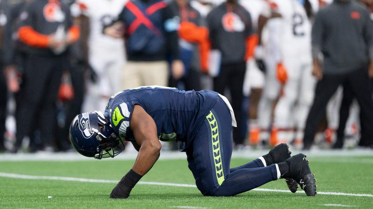 Seattle Seahawks linebacker Uchenna Nwosu (10) reacts to a chopblock that left him injured during the preseason game against the Cleveland Browns at Lumen Field, on Saturday, Aug. 24, 2024 in Seattle, Wash.