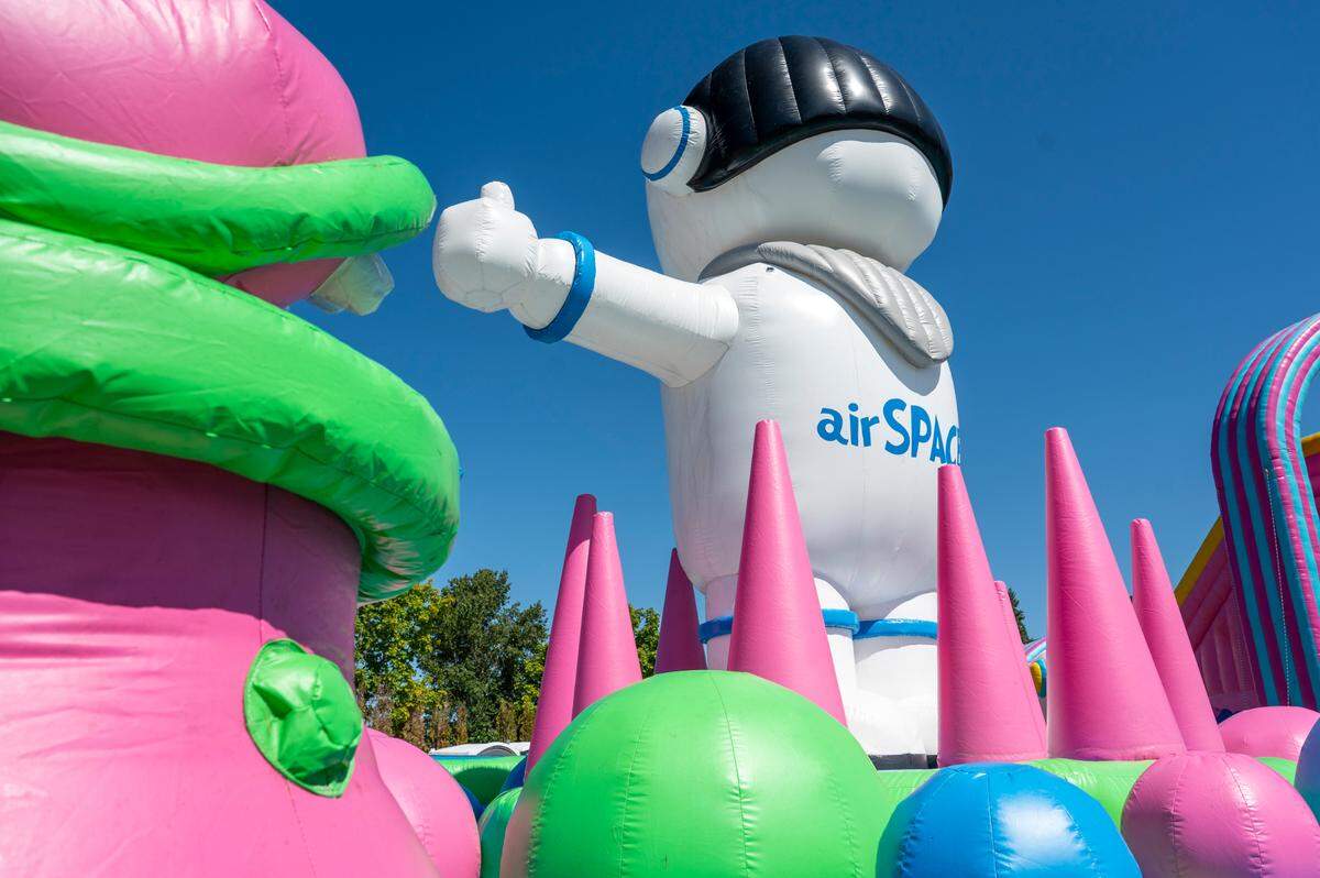 Additional bounce houses, including the Air Space, pictured here, The Giant, Sport Slam and City Escape are blown up in anticipation of weekend visitors at The Big Bounce America tour on Friday, July 11, 2025, at the Puyallup fairgrounds in Puyallup, Wash.