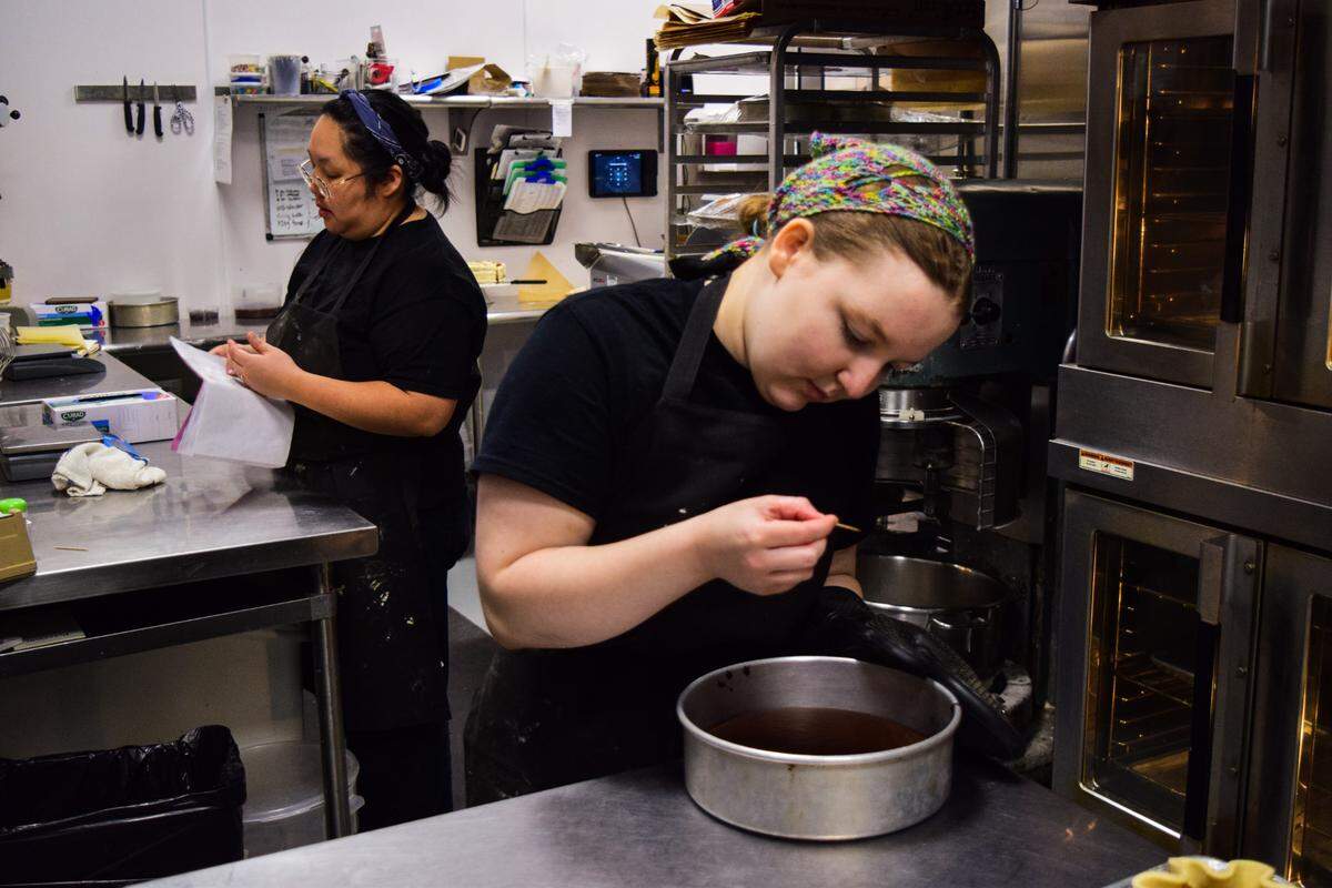 Becca Verkuyl tests a chocolate tea cake at Wren’s Nest Baking Co. on Wednesday, Oct. 23. The gluten-free bakery employs about 30 people after one year in business at 5121 S. Pearl St. in Ruston.