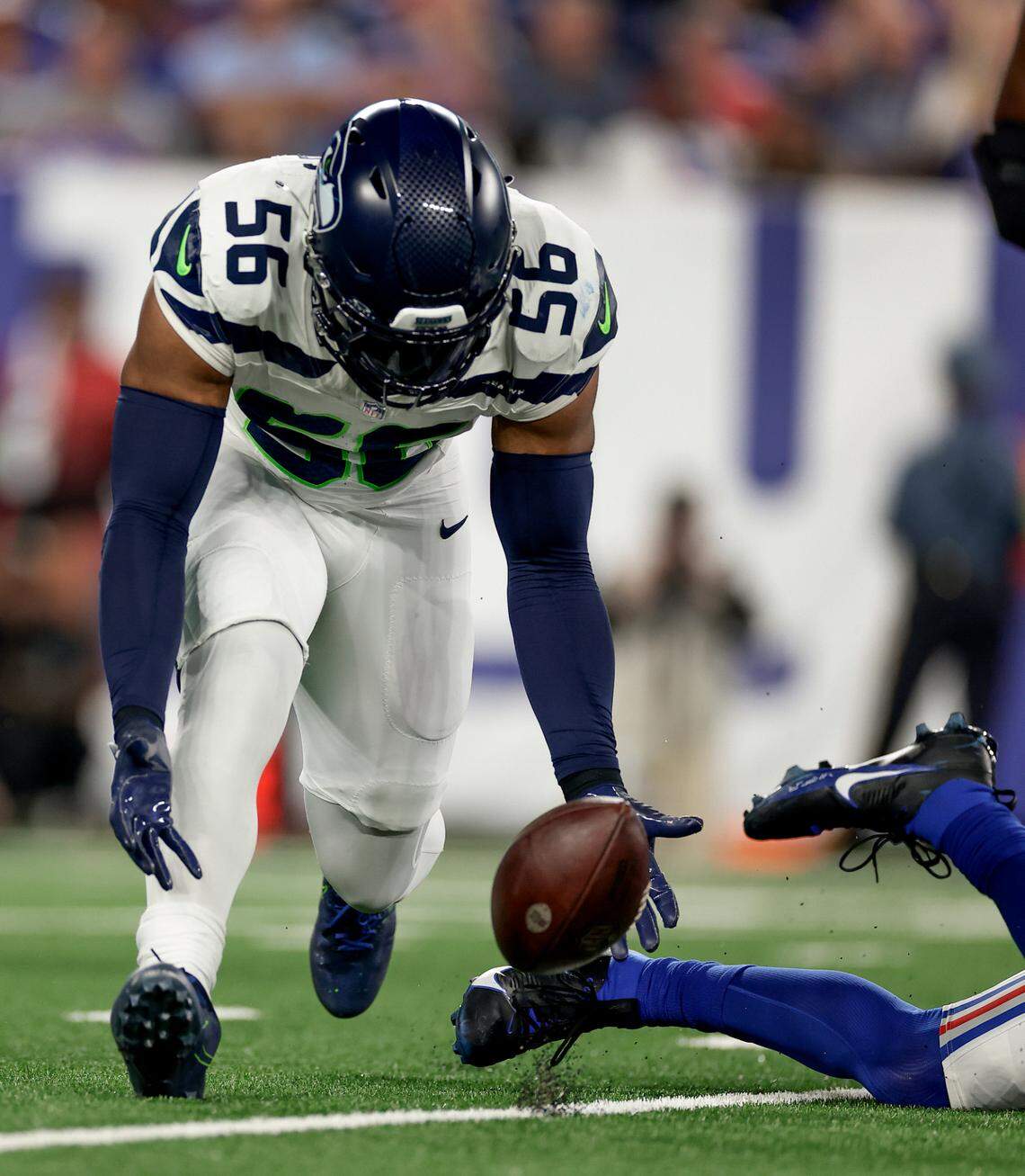 Seattle Seahawks linebacker Jordyn Brooks (56) recovers a fumble by New York Giants quarterback Daniel Jones during the second quarter of an NFL football game, Monday, Oct. 2, 2023, in East Rutherford, N.J. (AP Photo/Adam Hunger)
