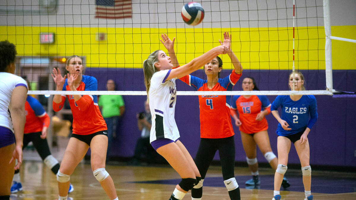 Puyallup sophomore setter Reese Sheppard sets a shot in front of Graham-Kapowsin defenders Natalie Nagel (left) and Grace Peterson during their regular season finale volleyball match at Puyallup High School in Puyallup, Washington, on Tuesday, Oct. 25, 2022. After dropping the first two games, 22-25 and 21-25, Puyallup rebounded to sweep the final three games, 25-22, 25-19 and 15-13, for the best of five victory.